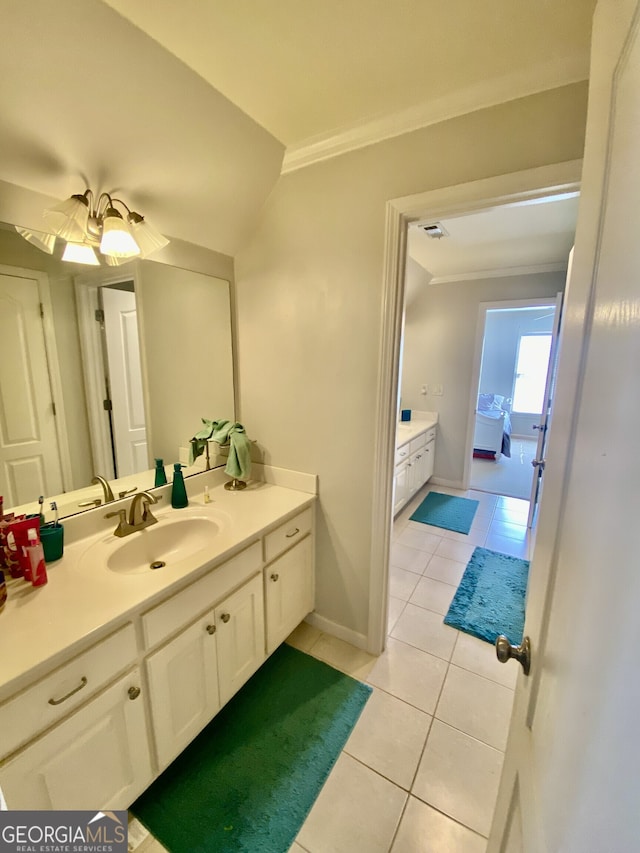 bathroom featuring visible vents, baseboards, vanity, ornamental molding, and tile patterned floors