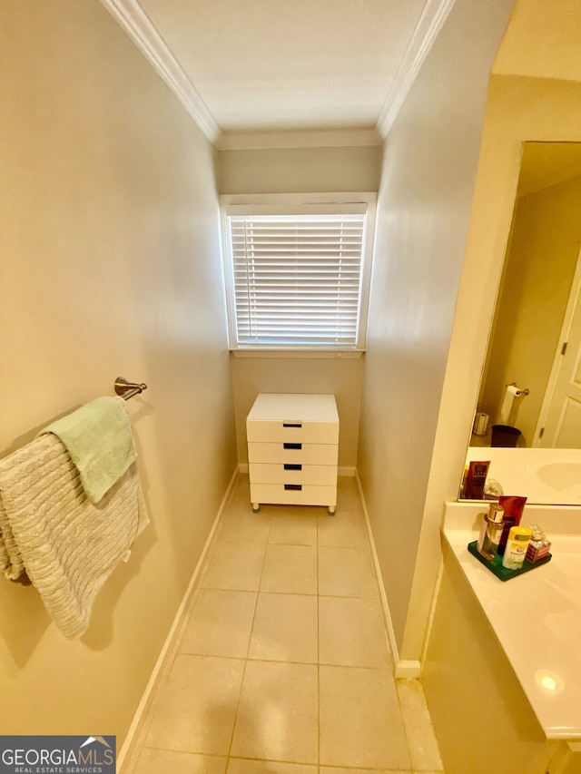 bathroom featuring ornamental molding, tile patterned flooring, and baseboards