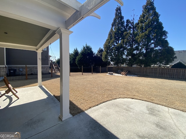 view of yard featuring an outdoor fire pit, a patio area, and a fenced backyard