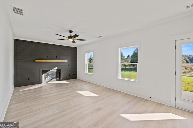 unfurnished living room featuring light wood-type flooring, visible vents, and crown molding