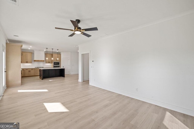 unfurnished living room with light wood finished floors, baseboards, ornamental molding, and a ceiling fan