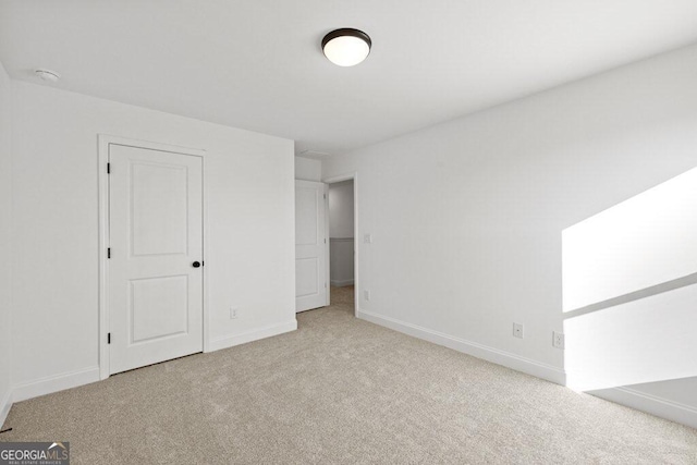 unfurnished bedroom featuring carpet floors and baseboards