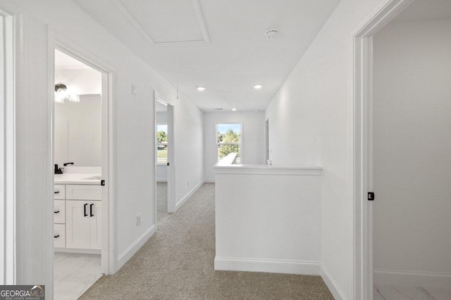 hall featuring attic access, recessed lighting, marble finish floor, and baseboards