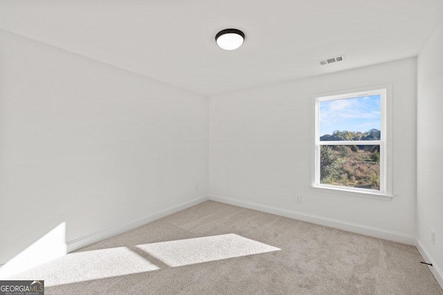 unfurnished room with light carpet, baseboards, and visible vents