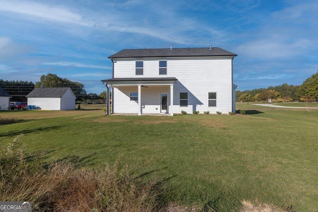 back of house featuring a lawn