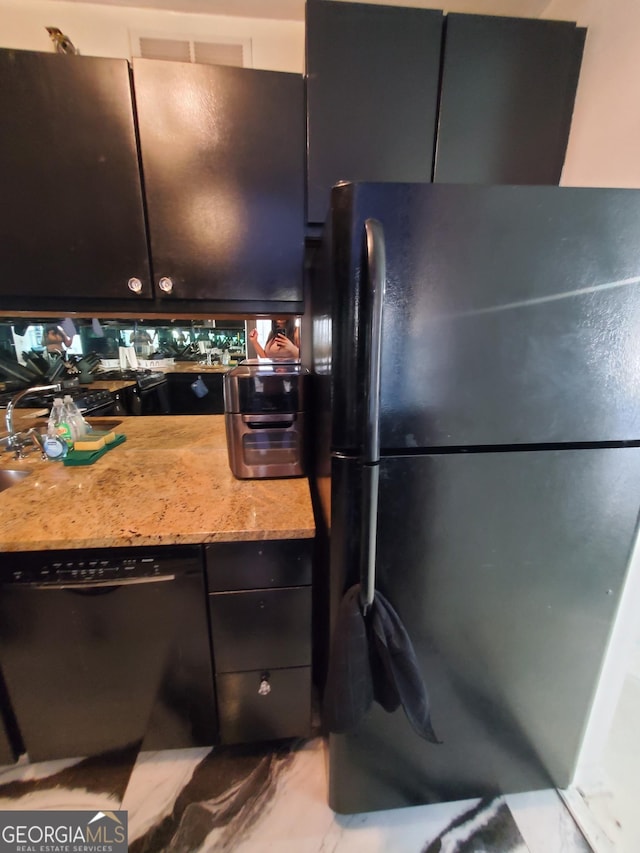 kitchen featuring black appliances and marble finish floor