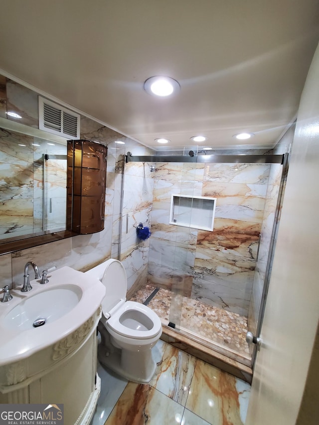 full bath featuring toilet, vanity, visible vents, marble finish floor, and a marble finish shower