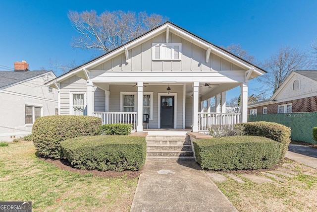 bungalow-style home with board and batten siding, a porch, and a ceiling fan