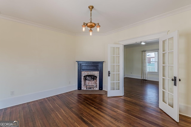 unfurnished living room featuring a fireplace with flush hearth, french doors, ornamental molding, and wood finished floors