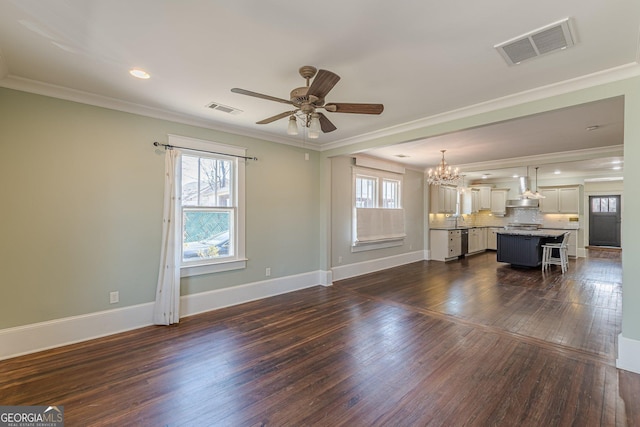 unfurnished living room featuring dark wood-type flooring, visible vents, baseboards, and ceiling fan with notable chandelier