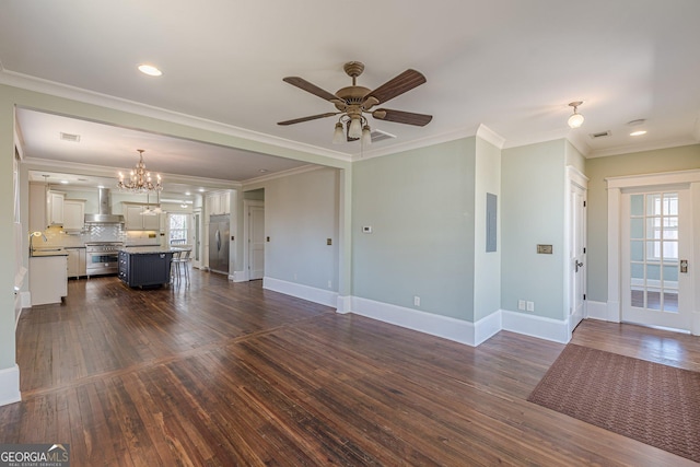 unfurnished living room with a healthy amount of sunlight, ceiling fan with notable chandelier, a sink, and dark wood-style flooring