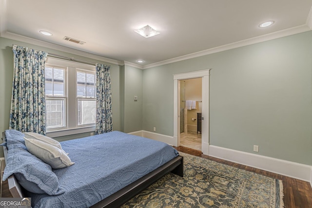 bedroom featuring visible vents, baseboards, wood finished floors, and ornamental molding