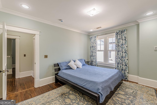 bedroom featuring baseboards, visible vents, ornamental molding, wood finished floors, and recessed lighting