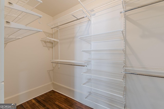 spacious closet with wood finished floors