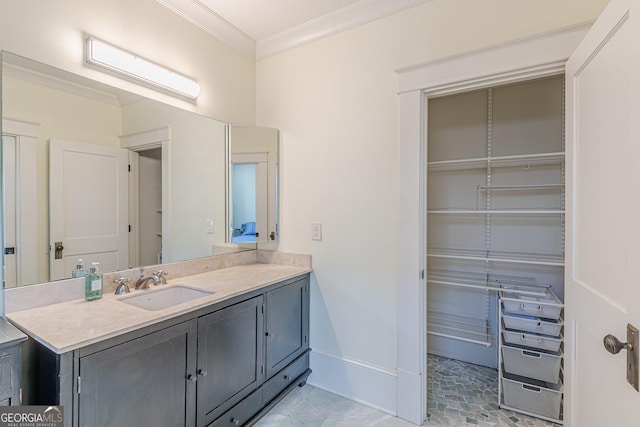 bathroom with crown molding, vanity, and baseboards