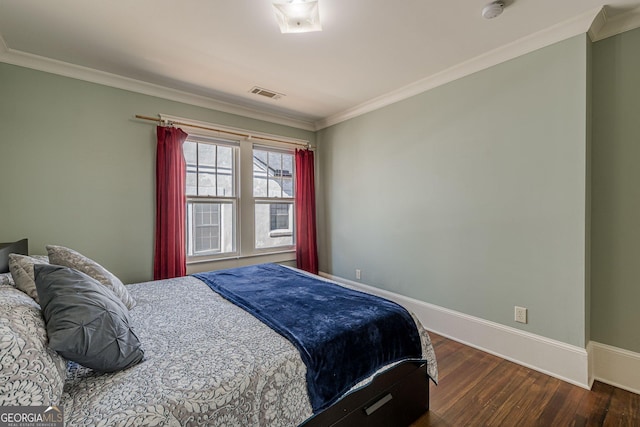 bedroom featuring dark wood-type flooring, baseboards, ornamental molding, and visible vents