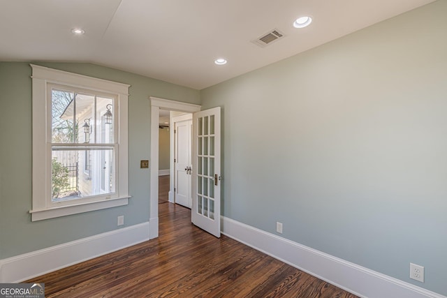 unfurnished room featuring baseboards, visible vents, dark wood-style floors, vaulted ceiling, and recessed lighting