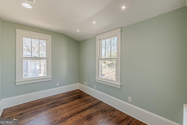 unfurnished room featuring baseboards, vaulted ceiling, dark wood-type flooring, and recessed lighting