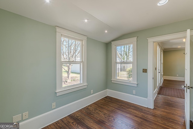 empty room featuring vaulted ceiling, dark wood-style flooring, recessed lighting, and baseboards