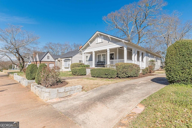 view of front of home with a porch, board and batten siding, and concrete driveway