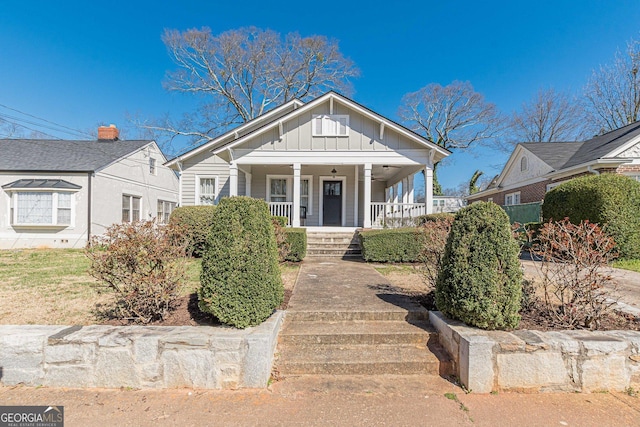 bungalow featuring covered porch and board and batten siding