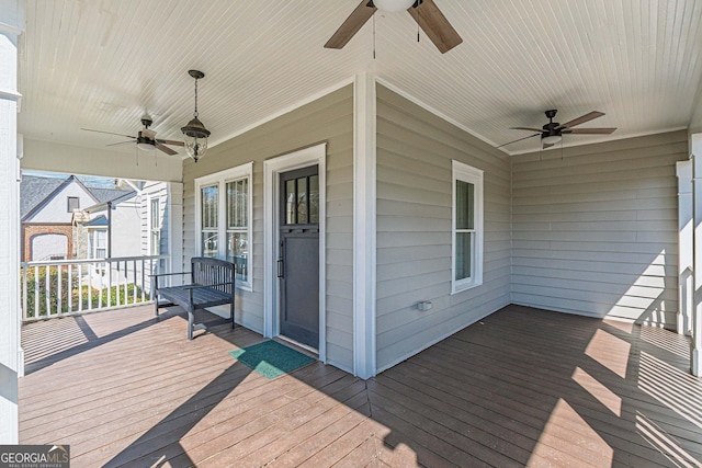 wooden terrace featuring a porch and a ceiling fan