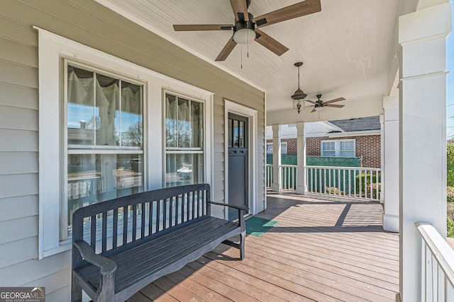 deck featuring covered porch and ceiling fan