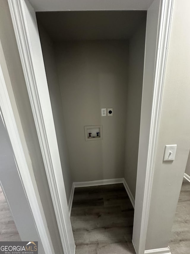 laundry area with hookup for a washing machine, electric dryer hookup, wood finished floors, laundry area, and baseboards