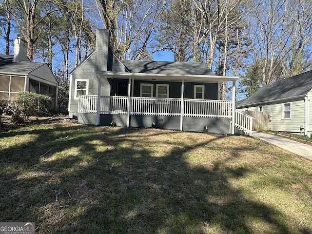 view of front of property featuring covered porch, a front lawn, a chimney, and a sunroom