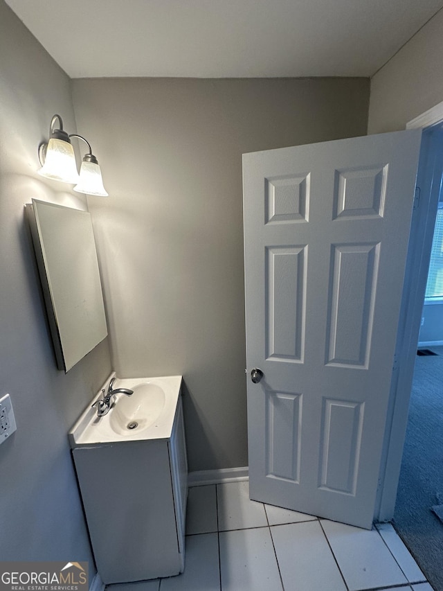 bathroom featuring baseboards, vanity, and tile patterned floors