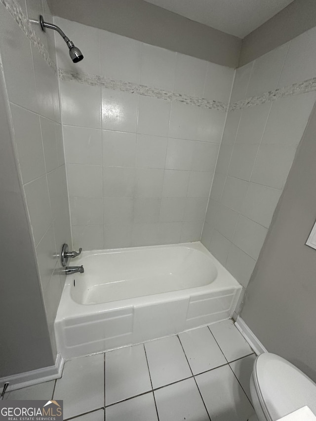 full bathroom featuring toilet, tile patterned flooring, baseboards, and shower / washtub combination