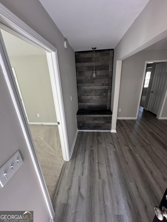 unfurnished living room with baseboards and wood finished floors