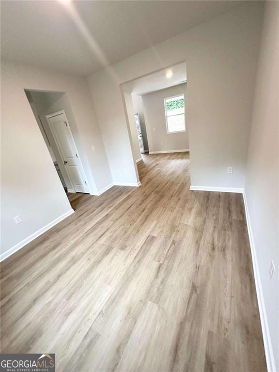 spare room with wood finished floors and baseboards