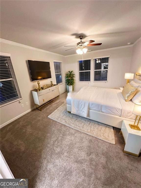 carpeted bedroom with baseboards, ornamental molding, and a ceiling fan