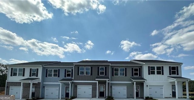 view of property featuring board and batten siding and an attached garage