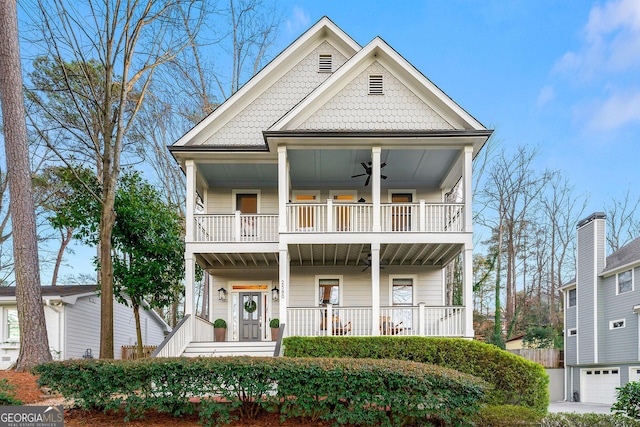 view of front facade with a ceiling fan, covered porch, and a balcony