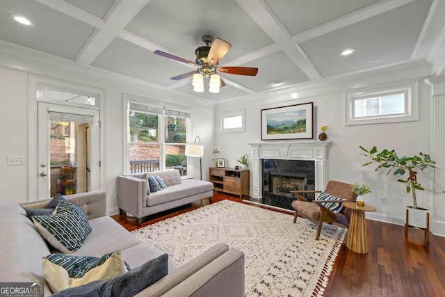 living area featuring dark wood-type flooring, coffered ceiling, a fireplace, and baseboards