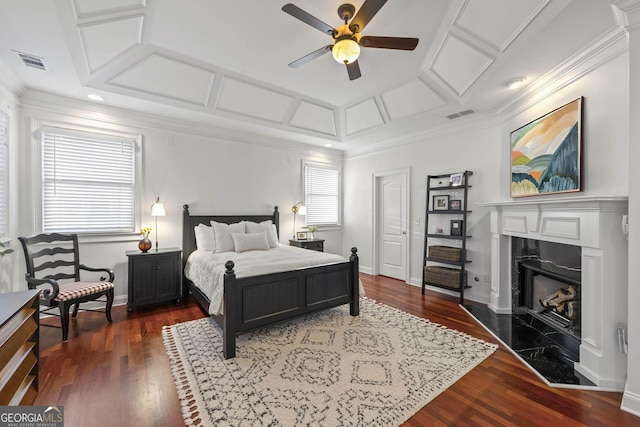 bedroom with a premium fireplace, visible vents, coffered ceiling, and wood finished floors