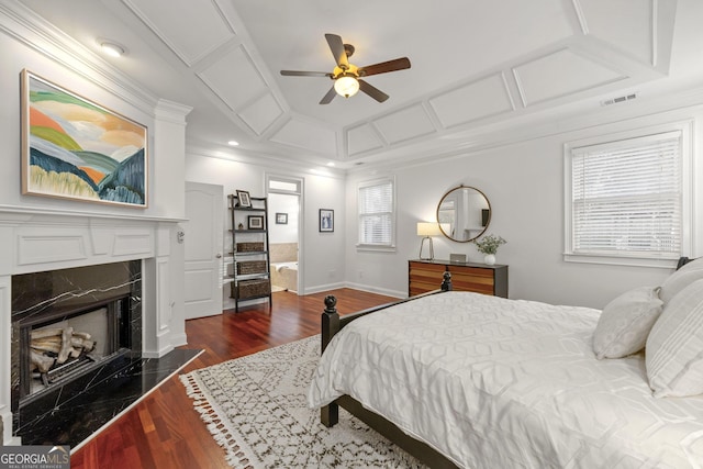 bedroom featuring dark wood-type flooring, a premium fireplace, coffered ceiling, visible vents, and multiple windows