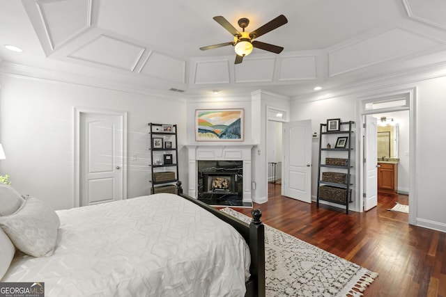 bedroom featuring baseboards, coffered ceiling, dark wood finished floors, crown molding, and recessed lighting