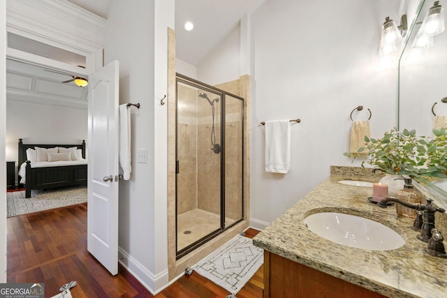 ensuite bathroom featuring a shower stall, connected bathroom, a sink, and wood finished floors