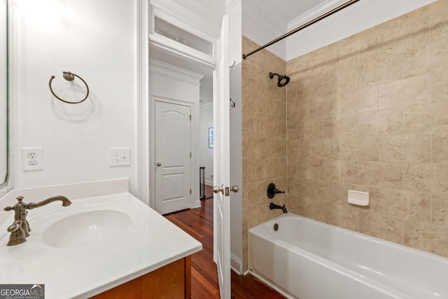 bathroom with vanity, ornamental molding, wood finished floors, and shower / bathing tub combination