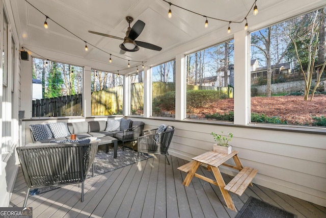 sunroom featuring a ceiling fan