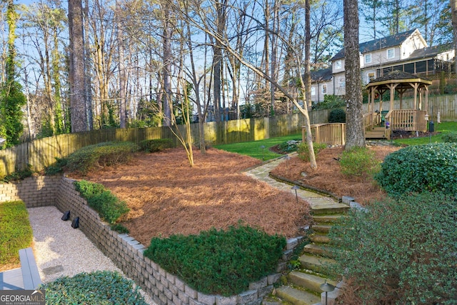 view of yard featuring fence and a gazebo