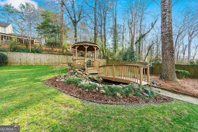 view of yard with a fenced backyard and a deck