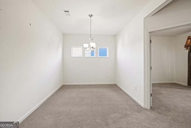 unfurnished dining area featuring carpet flooring, a notable chandelier, visible vents, and baseboards