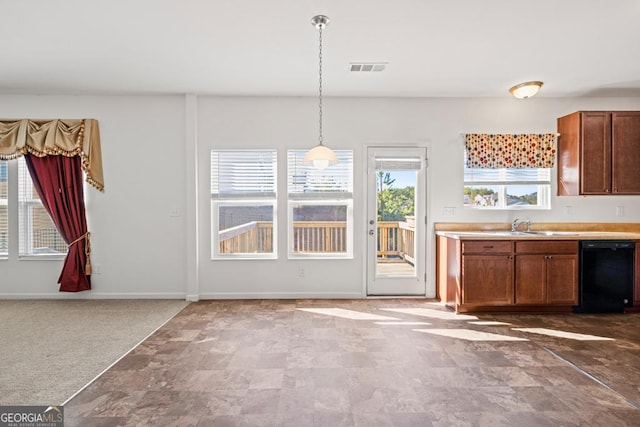 kitchen with black dishwasher, baseboards, decorative light fixtures, carpet, and light countertops