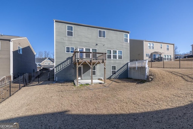 rear view of house with a deck, a fenced backyard, a patio, and stairway