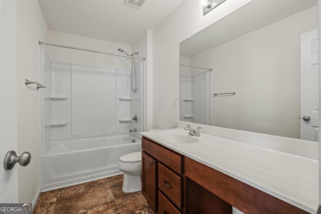 full bath featuring visible vents, bathing tub / shower combination, toilet, stone finish flooring, and vanity