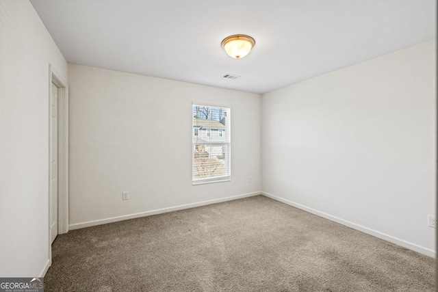 carpeted empty room with baseboards